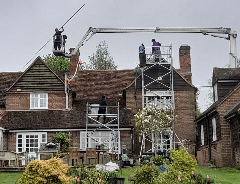The Roof Moss Cleaners using cherry picker and scaffolding to clean roof safely and professionally in Winchcombe, Gloucestershire